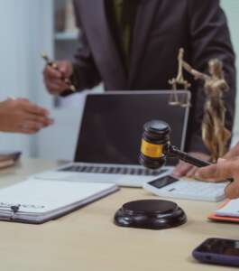 Three lawyers in a meeting at the table in an office, discussing business,civil and commercial law