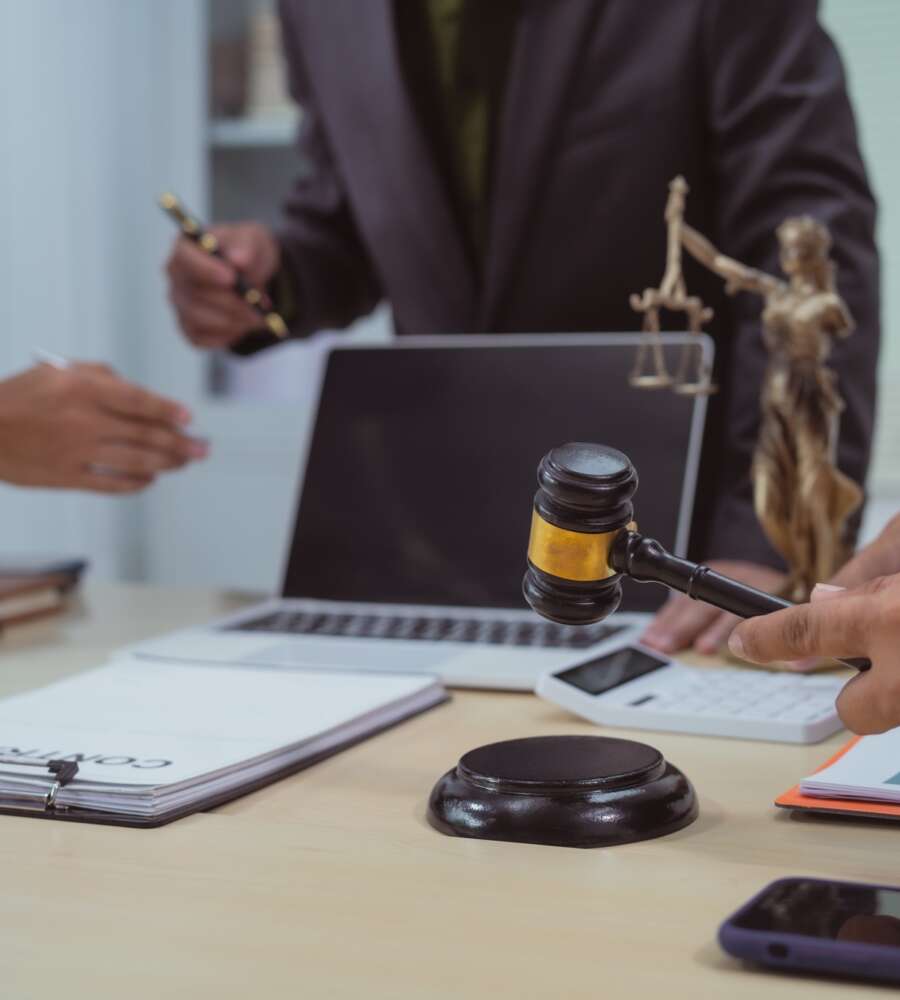 Three lawyers in a meeting at the table in an office, discussing business,civil and commercial law