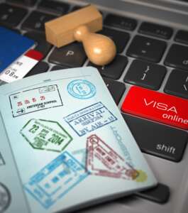 Visa online application concept. Open passport with visa stamps