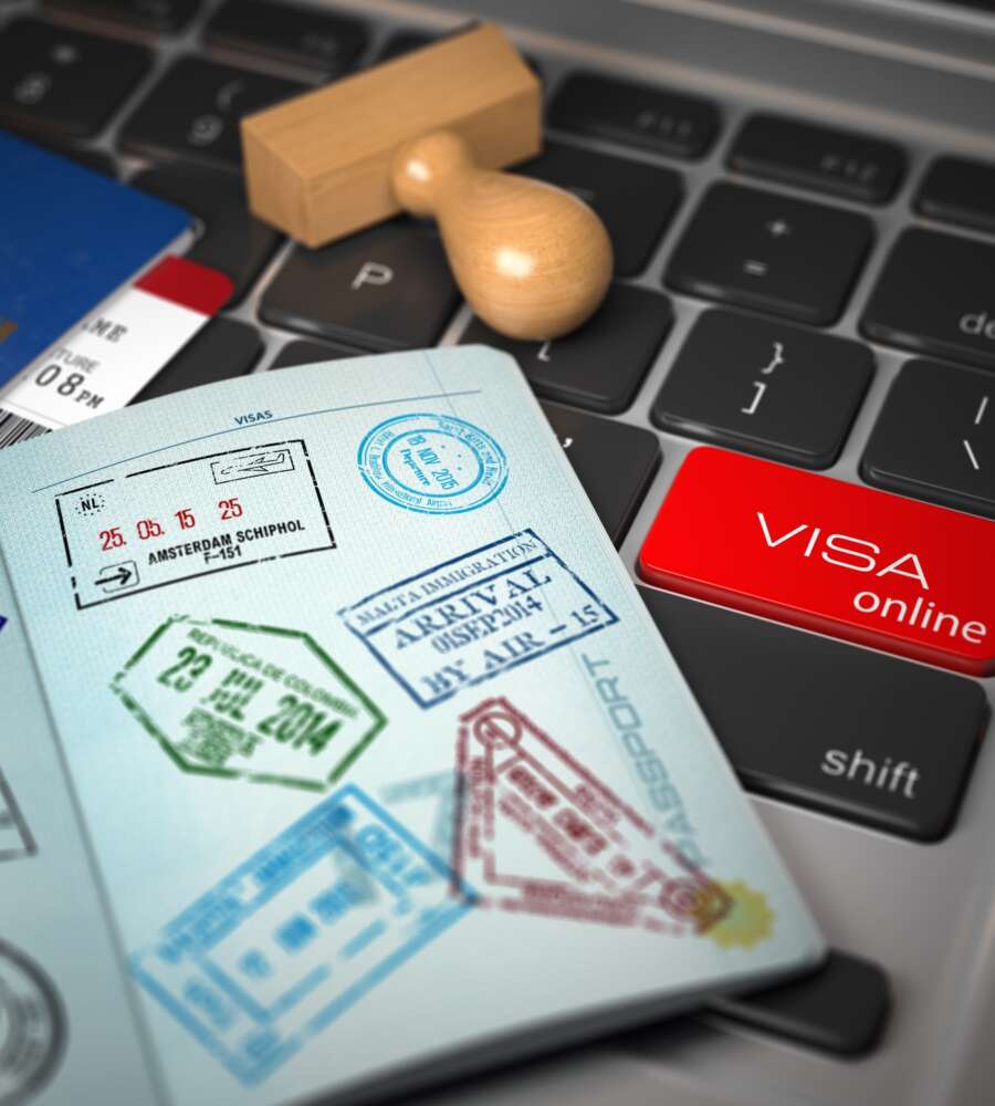 Visa online application concept. Open passport with visa stamps