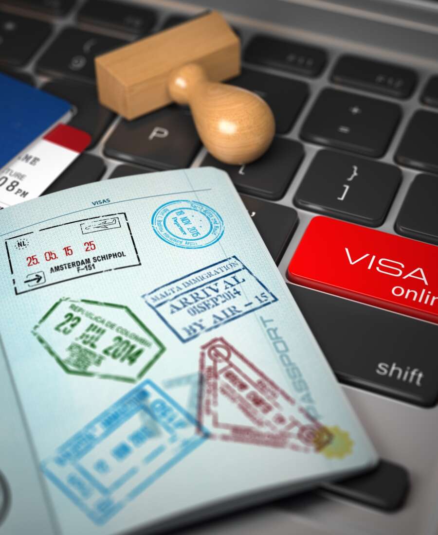 Visa online application concept. Open passport with visa stamps
