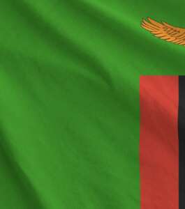 Zambia flag depicted on folded wavy fabric of old cloth