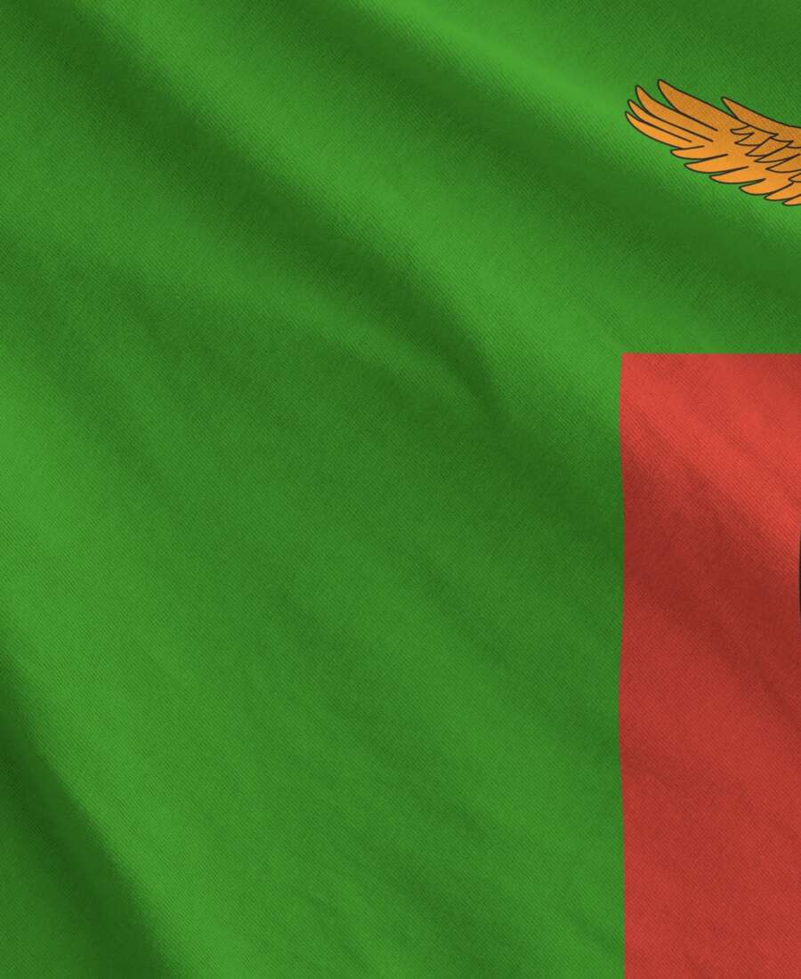 Zambia flag depicted on folded wavy fabric of old cloth